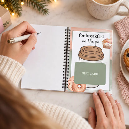 Preparing a personal note in a Christmas gift card book