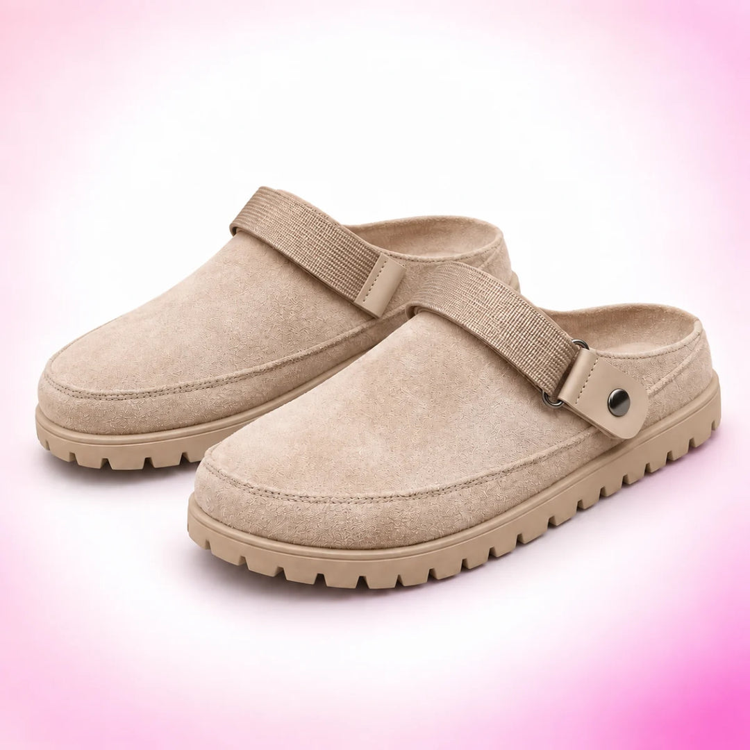 Khaki strappy clogs on a blush pink studio background