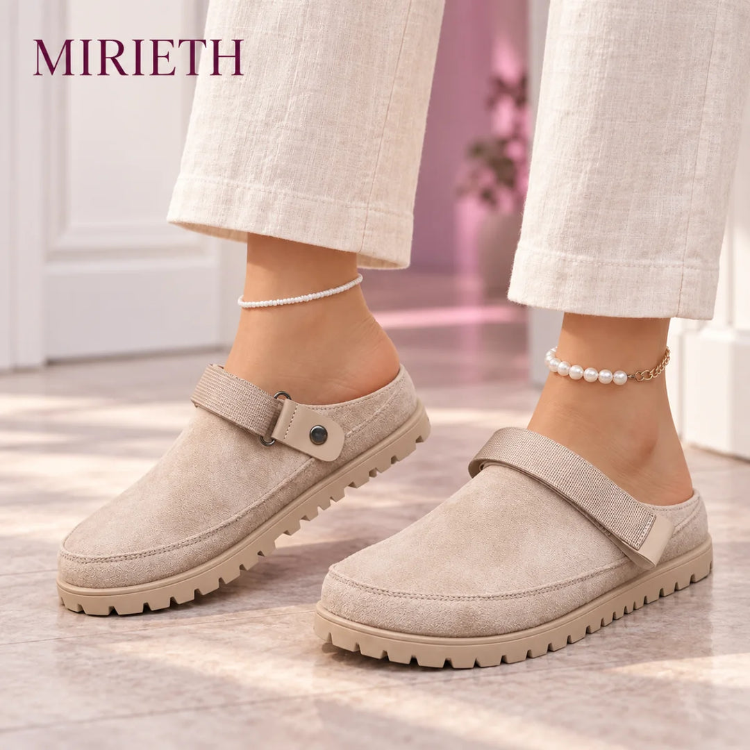 Khaki strappy clogs styled with cream linen pants