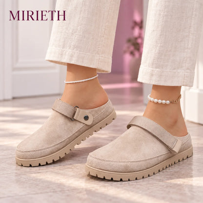 Khaki strappy clogs styled with cream linen pants
